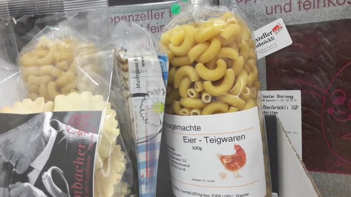 A box with locally-made elbow pasta, Appenzell cheese, cured beef and cookies