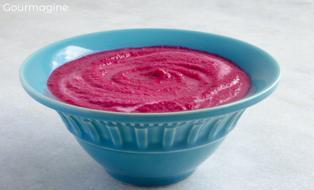 A blue-green bowl filled with beetroot cream soup