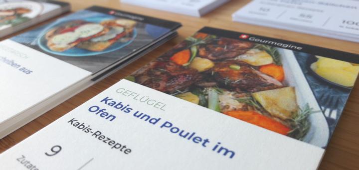 Flyers with Gourmagine recipes on a table