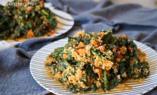 A plate filled with spinach, quinoa and carrots