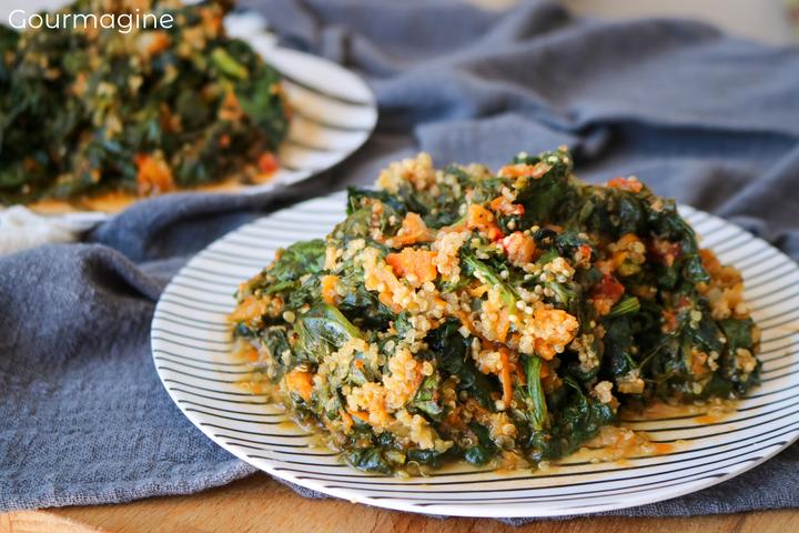 A plate filled with spinach, quinoa and carrots