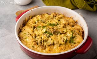 A baking dish filled with a cheese-topped courgette casserole