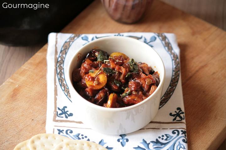 A white bowl filled with an aubergine caponata